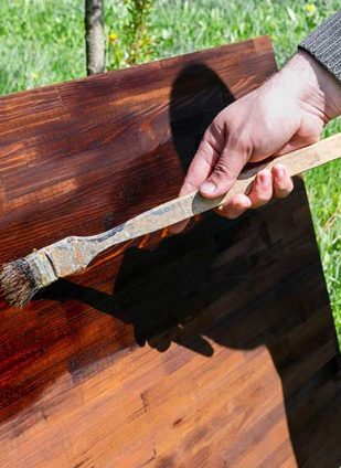 mans-male-hand-painting-wood-with-oil-wood-brown-2022-11-01-08-33-09-utc