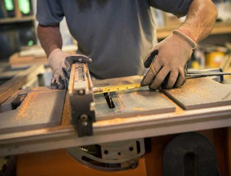 wood-artist-in-workshop-using-woodworking-machine-2022-03-07-23-57-28-utc